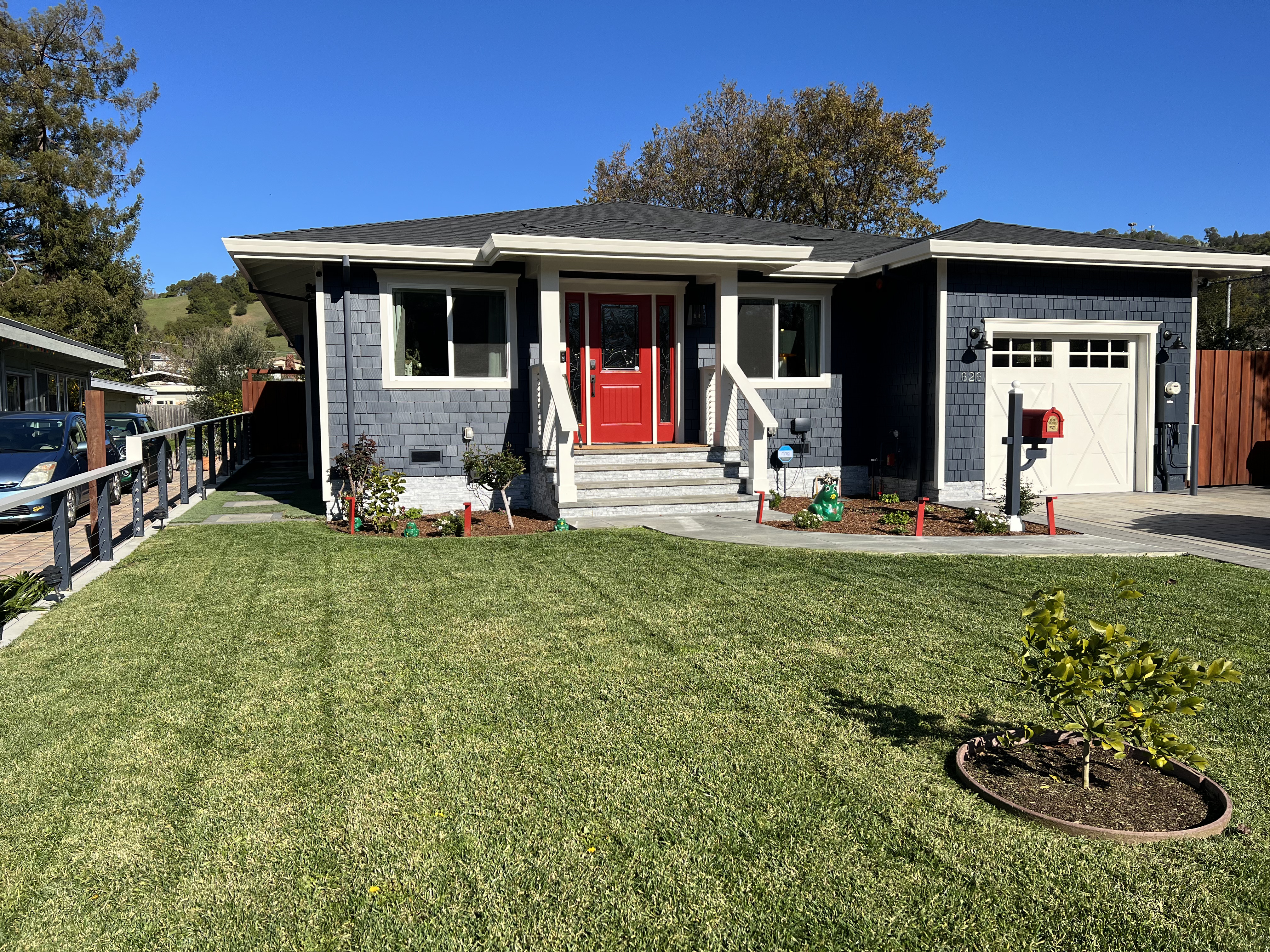 Navy blue craftsman style home exterior with white trim
