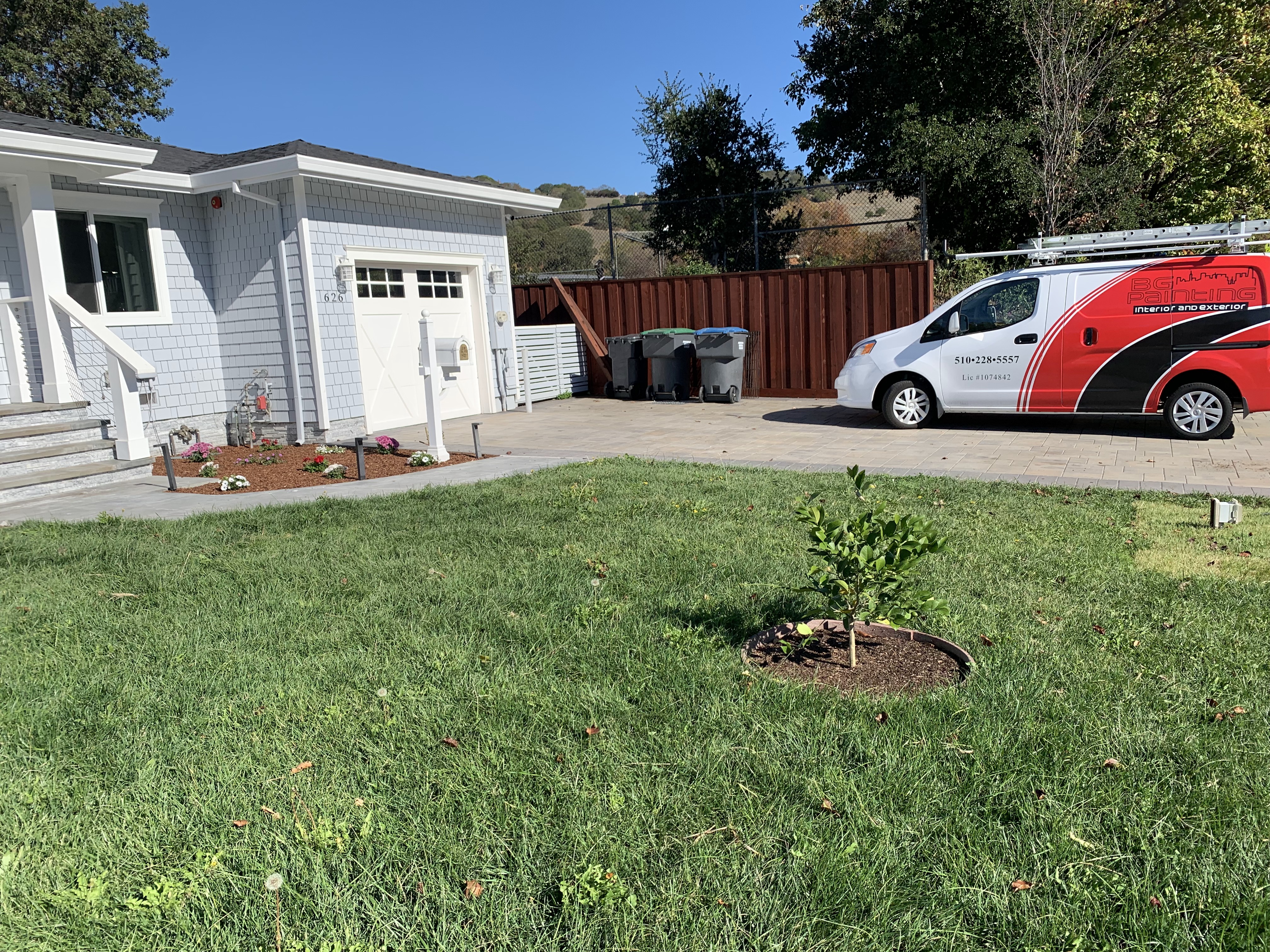 White exterior remodel with BG Painting service van
