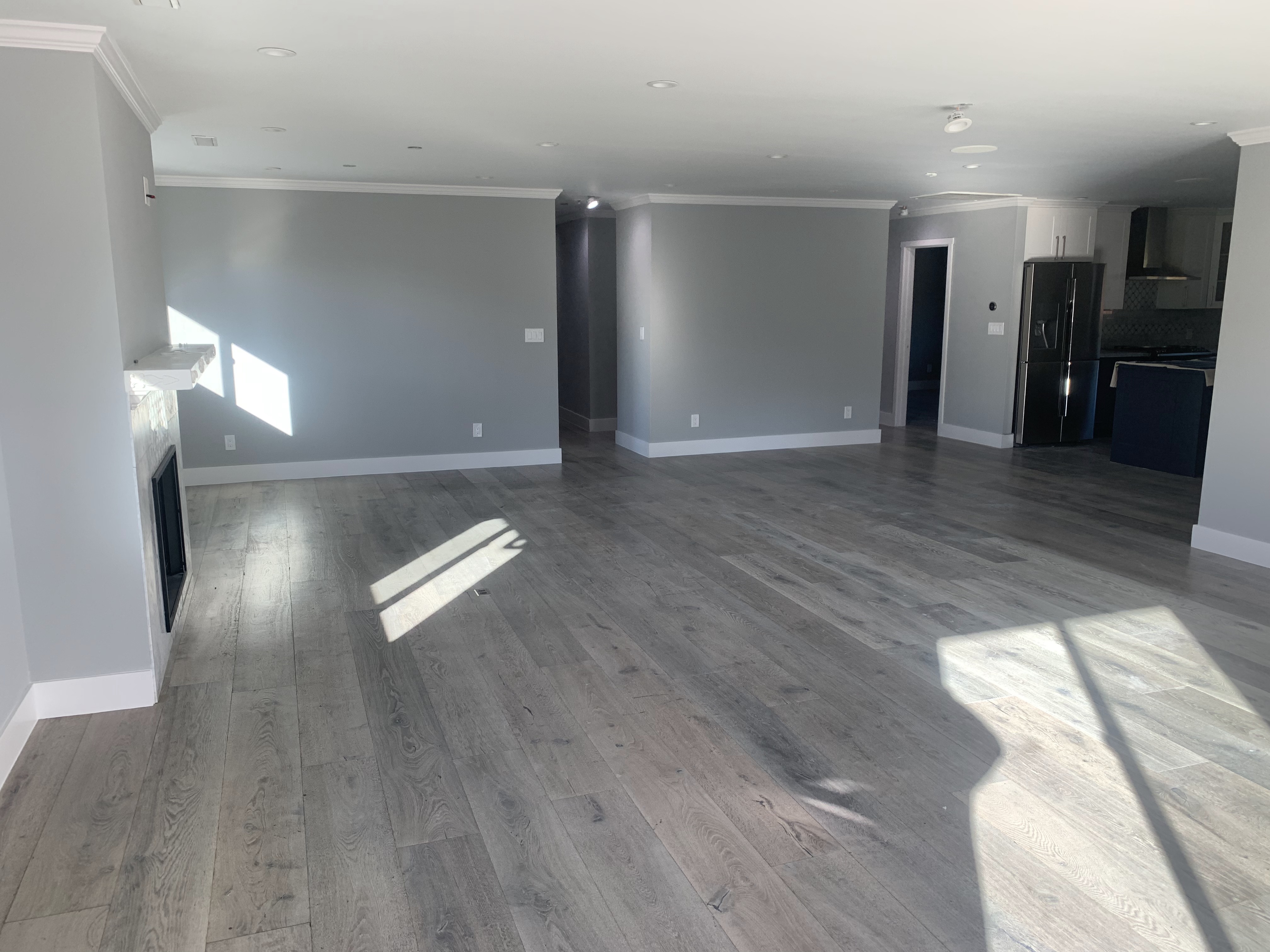 Open concept living room with gray walls and hardwood floors