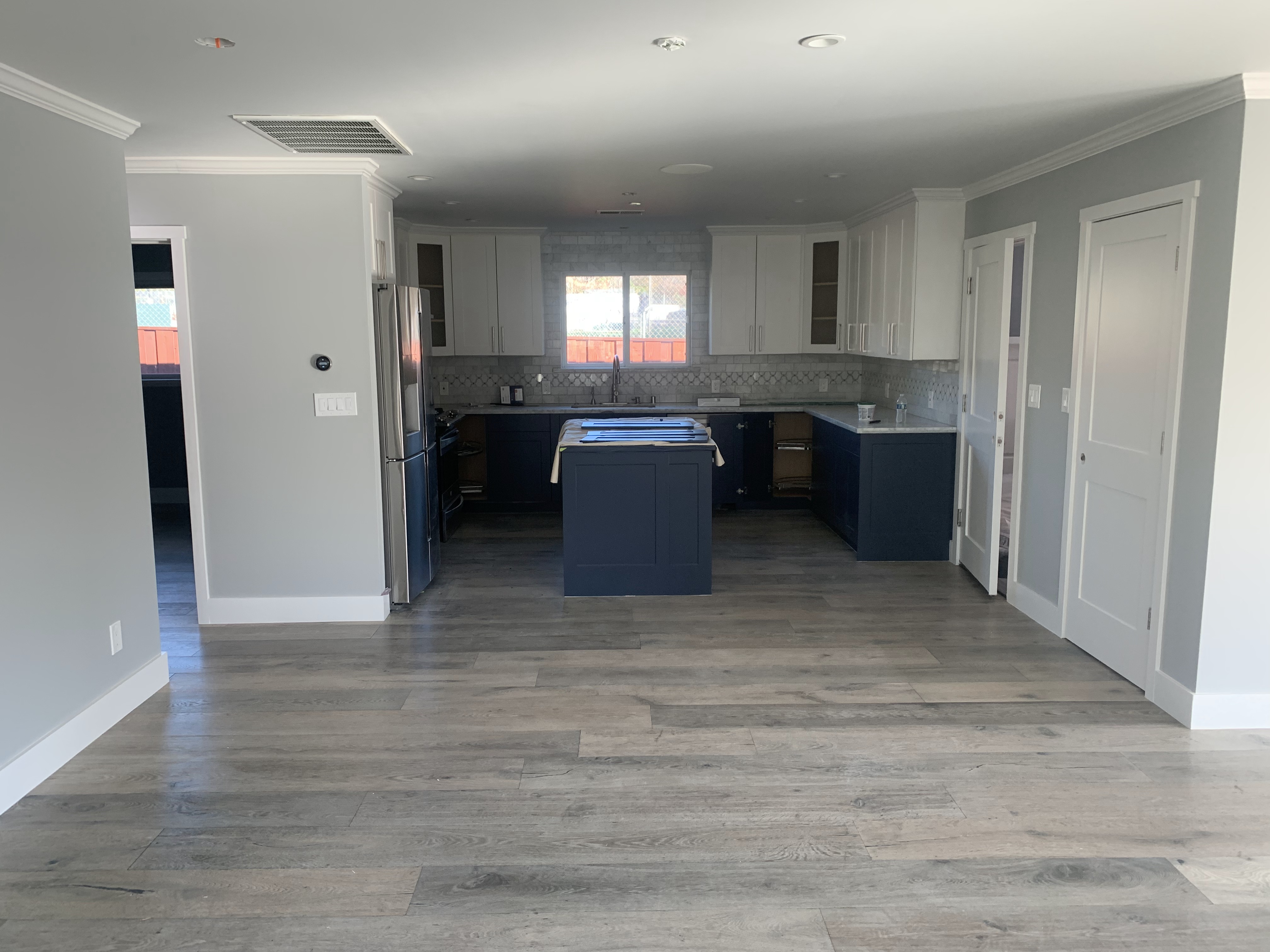 Modern kitchen with navy blue island and white cabinets