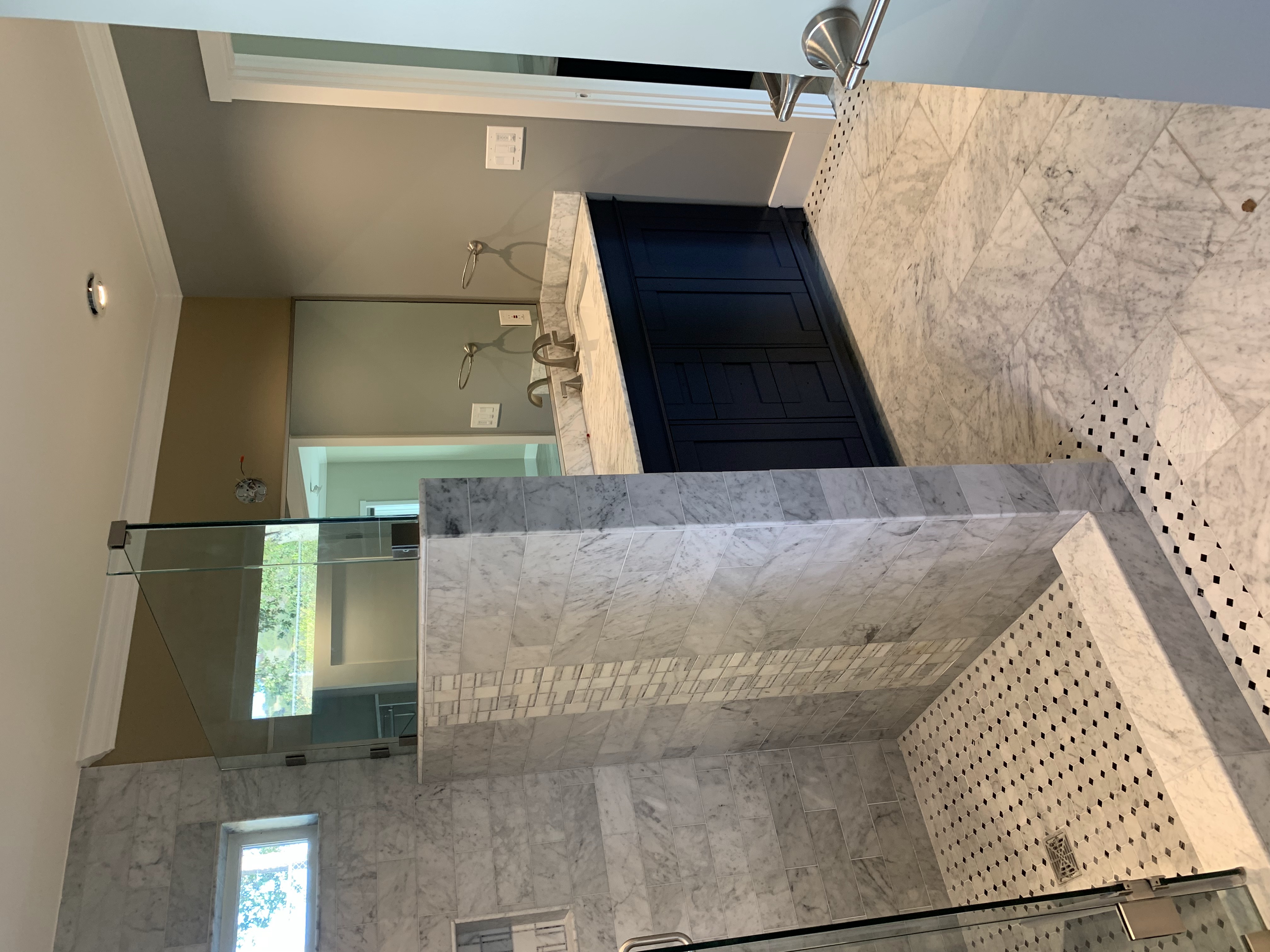 Luxury marble bathroom with navy door